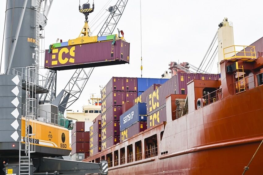 Container being lifted onto a cargo vessel